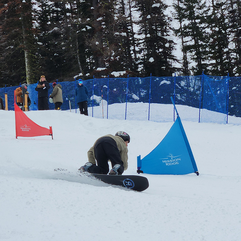 Snowboarder competing in the Skookum Kooker slalom snowboard race at Mission Ridge.