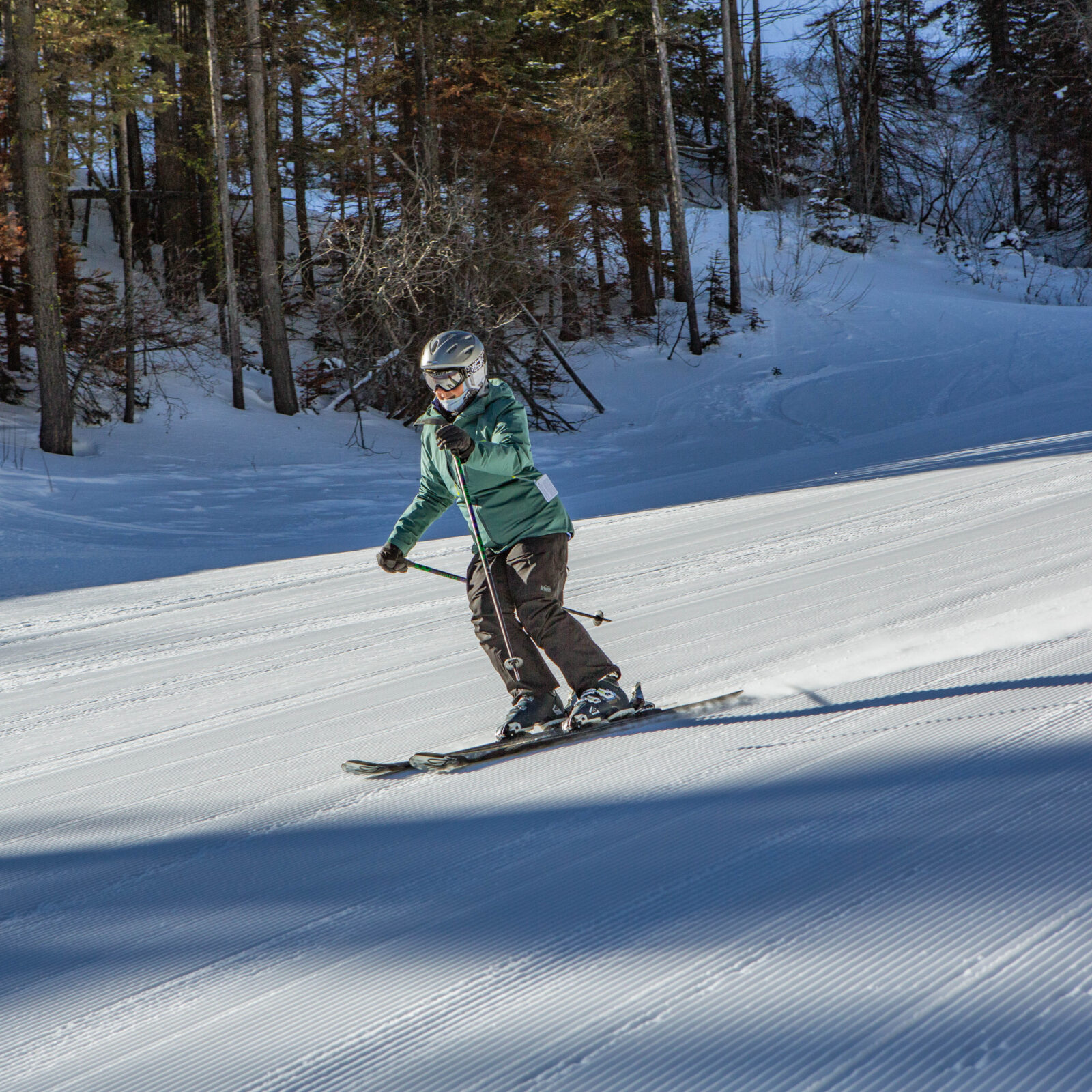 Skier enjoying morning corduroy on Mimi