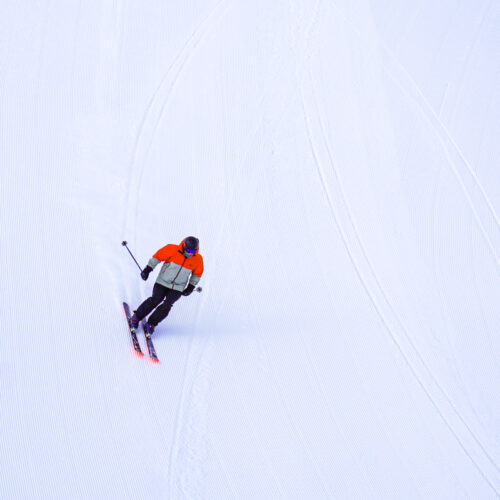 Skier descends freshly groomed Tumwater ski trail at Mission Ridge.