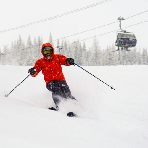 Skier descending Tumwater ski trail at Mission Ridge Resort with Chair 2 in background.