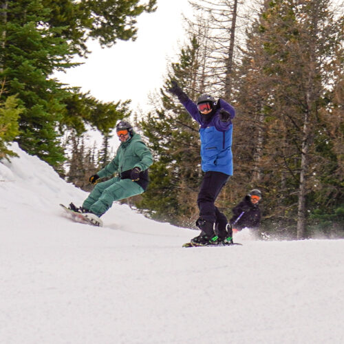 Two Snowboarders and a skier descend the Tillikum ski trail at Mission Ridge.