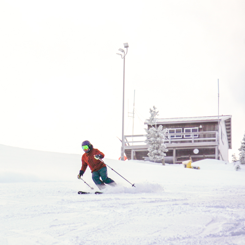 A skier descends beneath the ski patrol shack at the top of Mission Ridge.