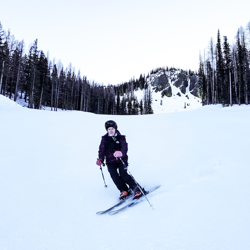 Skier descending a groomed run at Mission Ridge.