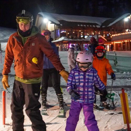 Father and daughter ride Chair 1 lift