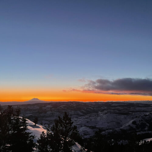 A view of the sunset from the top of Mission Ridge, with Mt. Rainier in the background.